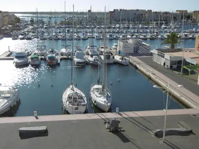 a group of boats docked in a harbor at Villa T4 Gruissan avec Vue Mer, Climatisée, 80m2, Plage à 50m, 6 Pers. - FR-1-796-100 in Gruissan