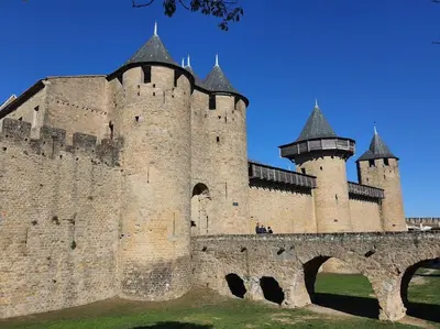 a large castle with turrets and a bridge at Tente Out of Africa in Alzonne