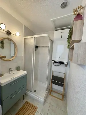 a bathroom with a shower and a sink at Pavillon avec piscine à deux pas de la plage in Gruissan