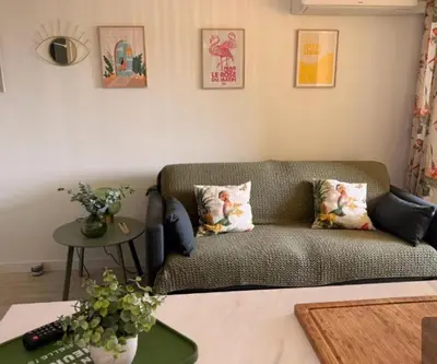 a living room with a couch and a table at Le Petit Grazel in Gruissan