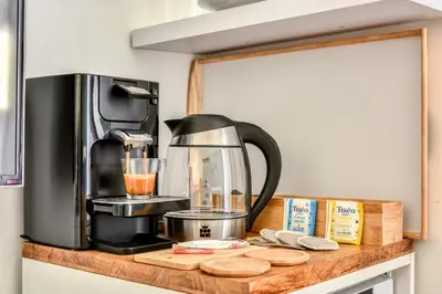 a coffee maker on top of a wooden counter at Le Bourget - Suite et Envolée romantique avec Jacuzzi in Narbonne