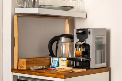 a coffee maker on a shelf in a kitchen at Le Bourget - Suite et Envolée romantique avec Jacuzzi in Narbonne