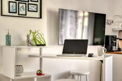 a white desk with a laptop on top of it at Le Bourget - Suite et Envolée romantique avec Jacuzzi in Narbonne