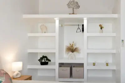a white living room with white shelves at Kavi-T3 Cozy - Medieval City 4 min - Air-Conditioning-Parking in Carcassonne