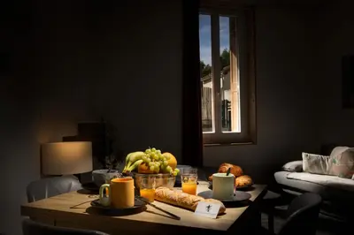 a table with a bowl of fruit on top of it at Kavi-T3 Cozy - Medieval City 4 min - Air-Conditioning-Parking in Carcassonne