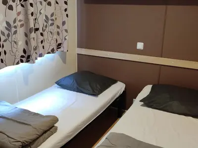 a room with two beds in a room at Mobil-home 6 Pers avec Terrasse à Axat - API-1-52-973 in Axat
