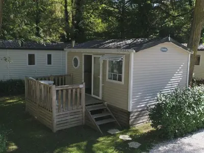 a small house with a porch and a door at Mobil-home 6 Pers avec Terrasse à Axat - API-1-52-973 in Axat