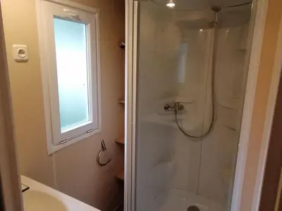 a bathroom with a shower and a sink and a window at Mobil-home avec Terrasse à Axat - API-1-52-1004 in Axat