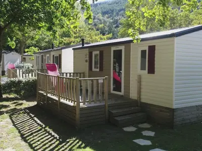 a tiny house with a porch and a deck at Mobil-home avec Terrasse à Axat - API-1-52-1004 in Axat