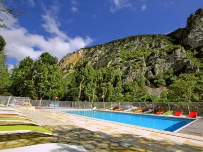 a swimming pool with a mountain in the background at Mobil-home avec Terrasse à Axat - API-1-52-1004 in Axat