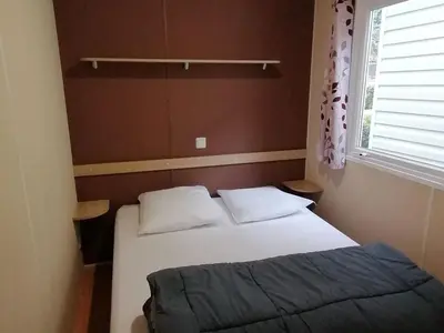 a small bedroom with a bed and a window at Mobil-home avec Terrasse à Axat - API-1-52-1004 in Axat