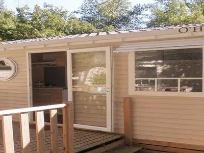 a house with a porch with a sliding glass door at Mobil-home 2 pers. avec terrasse à Axat - API-1-52-1188 in Axat