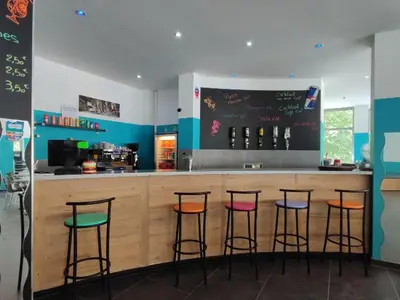 a bar with four bar stools in a kitchen at Mobil-home 2 pers. avec terrasse à Axat - API-1-52-1188 in Axat