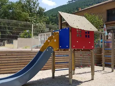 a playground with a slide and a play structure at Mobil-home 2 pers. avec terrasse à Axat - API-1-52-1188 in Axat