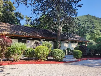 a building with a bunch of bushes in front of it at Mobil-home 2 pers. avec terrasse à Axat - API-1-52-1188 in Axat