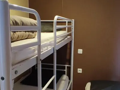 a couple of bunk beds in a room at Mobil home avec Terrasse, 2 Chambres, 5 Personnes - API-1-52-1140 in Axat