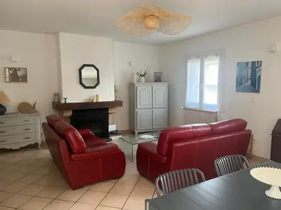 a living room with two red chairs and a table at MCC House, cozy accommodation with terrace and BBQ in Quillan