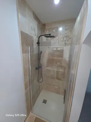a shower with a glass door in a bathroom at YZA Lodge 2026 in Castelnaudary