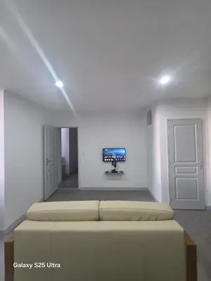 a room with two beds and a tv on the wall at YZA Lodge 2026 in Castelnaudary