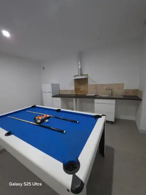 a pool table with two cuesticks on top of it at YZA Lodge 2026 in Castelnaudary