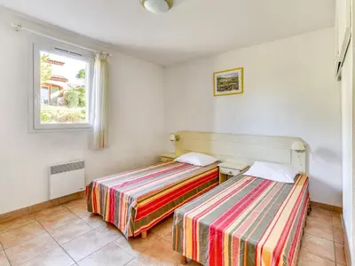 two beds in a room with a window at P Minervois J N07 Villa 3P4 in Homps
