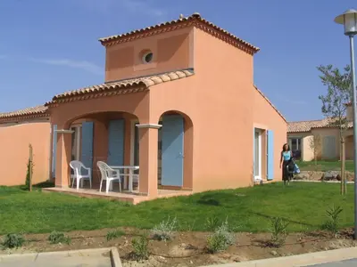 a woman standing in front of a house at P Minervois J N07 Villa 3P4 in Homps