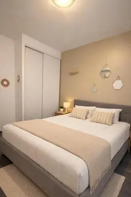 a bedroom with a large bed in a room at Magnifique T3 - à 5 min de la Cité Médiévale in La Celle-sous-Gouzon
