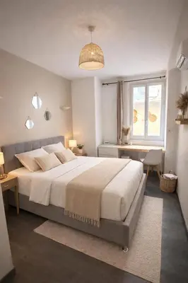 a bedroom with a large bed and a window at Magnifique T3 - à 5 min de la Cité Médiévale in La Celle-sous-Gouzon
