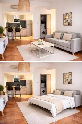 a living room with a large bed and a table at Magnifique T2 - à 5 min de la Cité Médiévale in Carcassonne