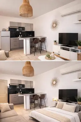 a living room and dining room with a large television at Magnifique T2 - à 5 min de la Cité Médiévale in Carcassonne