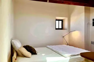 a small bedroom with a bed in a room at Studio à 5 min des halls in Narbonne