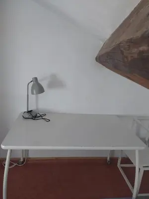 a white table with a lamp on top of it at Studio à 5 min des halls in Narbonne