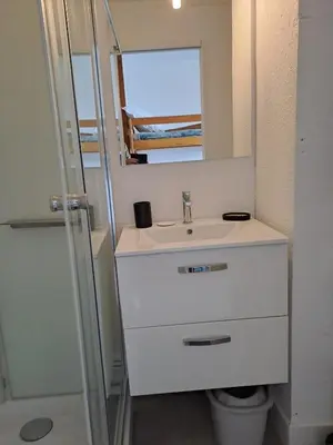 a bathroom with a sink and a mirror at Studio rénové avec piscine et accès direct plage in Gruissan