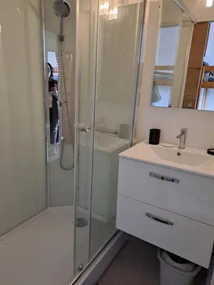 a bathroom with a shower and a sink at Studio rénové avec piscine et accès direct plage in Gruissan
