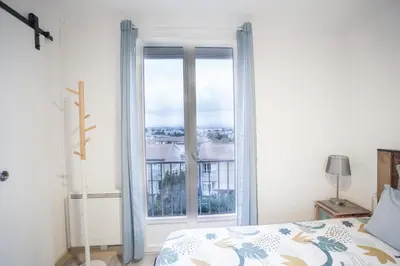 a bedroom with a bed and a large window at Terrasse et parking a 500m de la Cite AR in Carcassonne