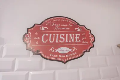 a sign hanging on the wall of a building at Terrasse et parking a 500m de la Cite AR in Carcassonne