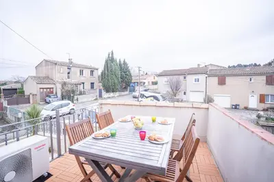 a table on a balcony with food on it at Terrasse et parking a 500m de la Cite AR in Carcassonne
