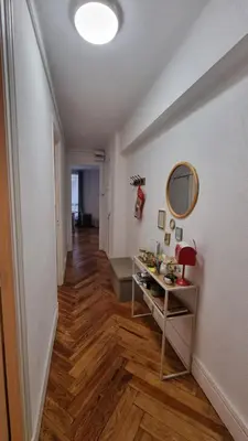 a hallway with a table and a mirror on a wall at Le Colibri Carcassonne Meublé de Tourisme 3 Etoiles in Carcassonne