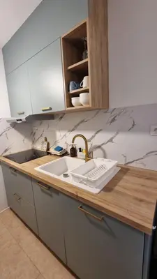 a kitchen with a sink and a counter top at Le Colibri Carcassonne Meublé de Tourisme 3 Etoiles in Carcassonne