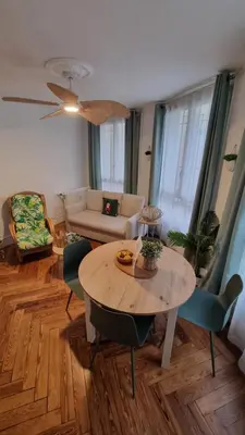 a living room with a table and chairs at Le Colibri Carcassonne Meublé de Tourisme 3 Etoiles in Carcassonne