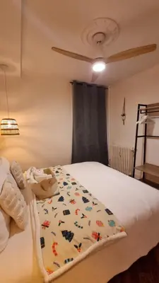 a bedroom with a bed with a blanket on it at Le Colibri Carcassonne Meublé de Tourisme 3 Etoiles in Carcassonne