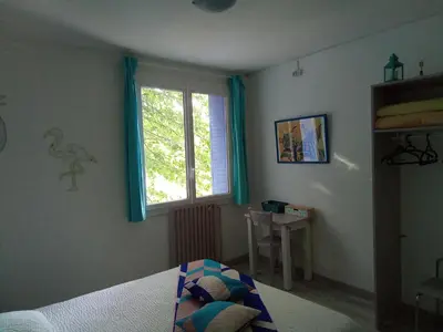 a bedroom with a bed and a window at Le fécos in Limoux