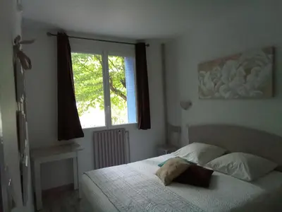 a bedroom with a bed and a window at Le fécos in Limoux