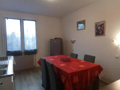 a room with a table with a red table cloth on it at Le fécos in Limoux