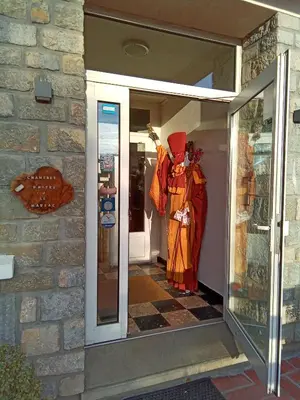 a store front with a mannequin standing in a doorway at Le fécos in Limoux
