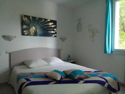 a bedroom with a bed with two pillows on it at Le fécos in Limoux