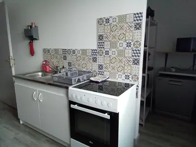 a small kitchen with a stove and a sink at Le fécos in Limoux