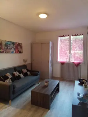 a living room with a couch and a coffee table at Le fécos in Limoux