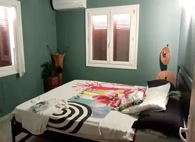 a bed in a bedroom with green walls at Villa Pamprenelle in Poilhès
