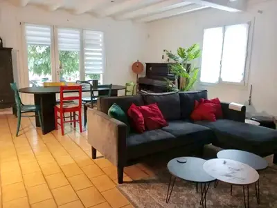a living room with a couch and a table at Villa Pamprenelle in Poilhès
